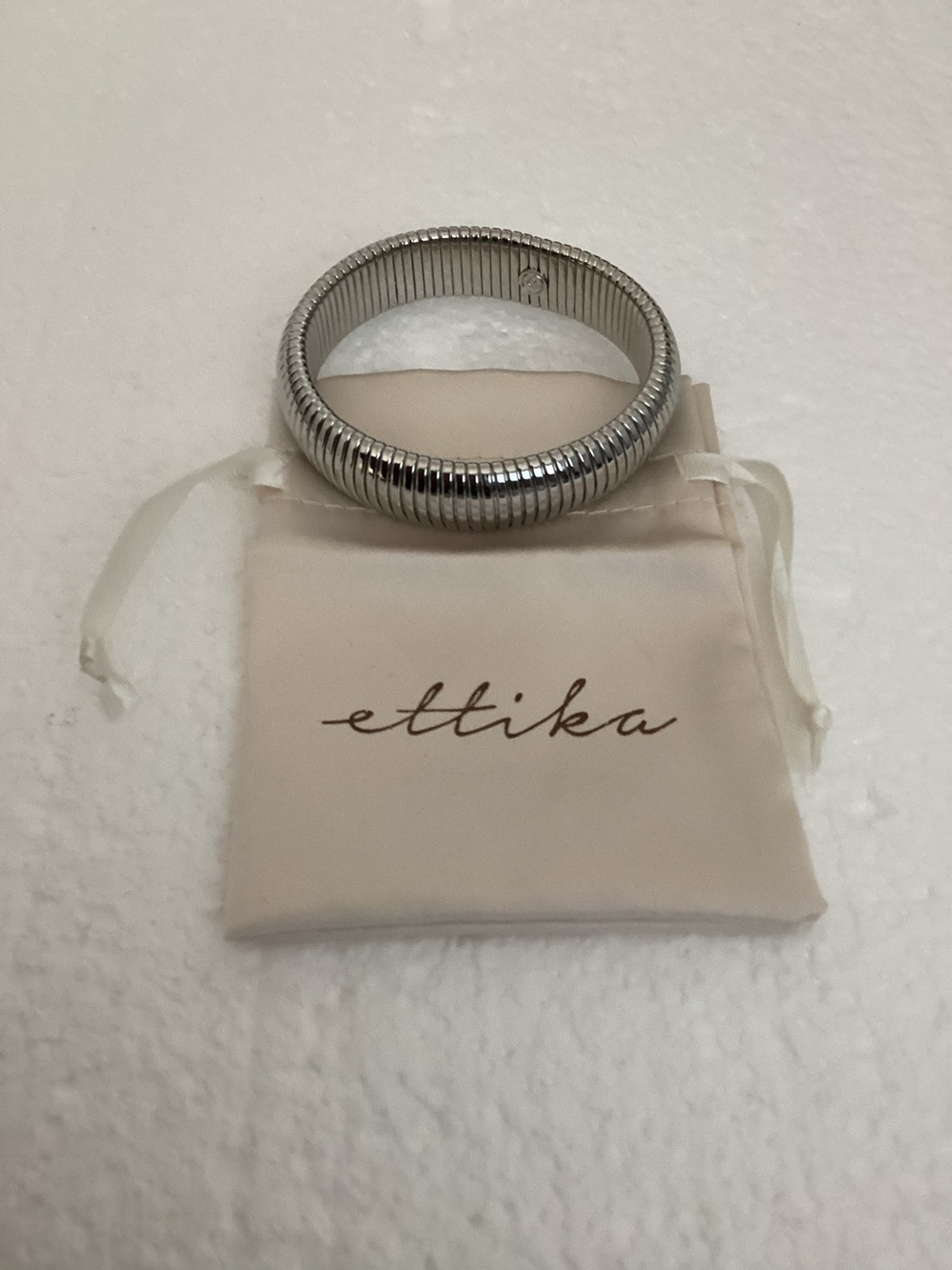 This Ettika silver-plated flexible tubogas-style stretch cuff silver tone brace